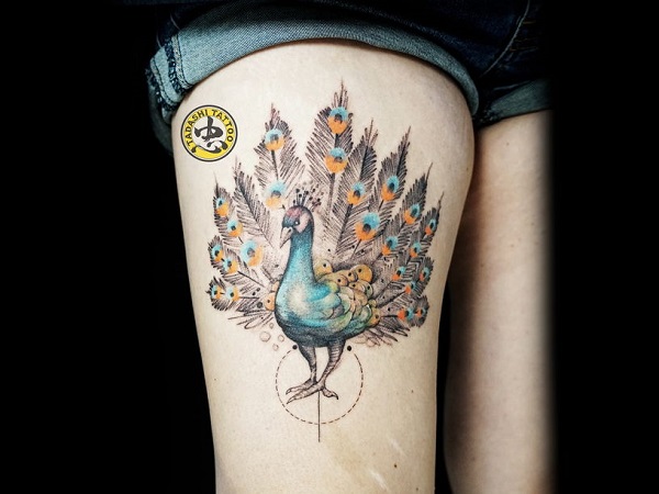 Peacock tattoo on thigh by artist Kim Hieu